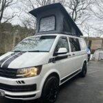 Modern 4 berth VW T6 camper van with fold-out seats and stylish interior, available to hire from NW Car Hire.