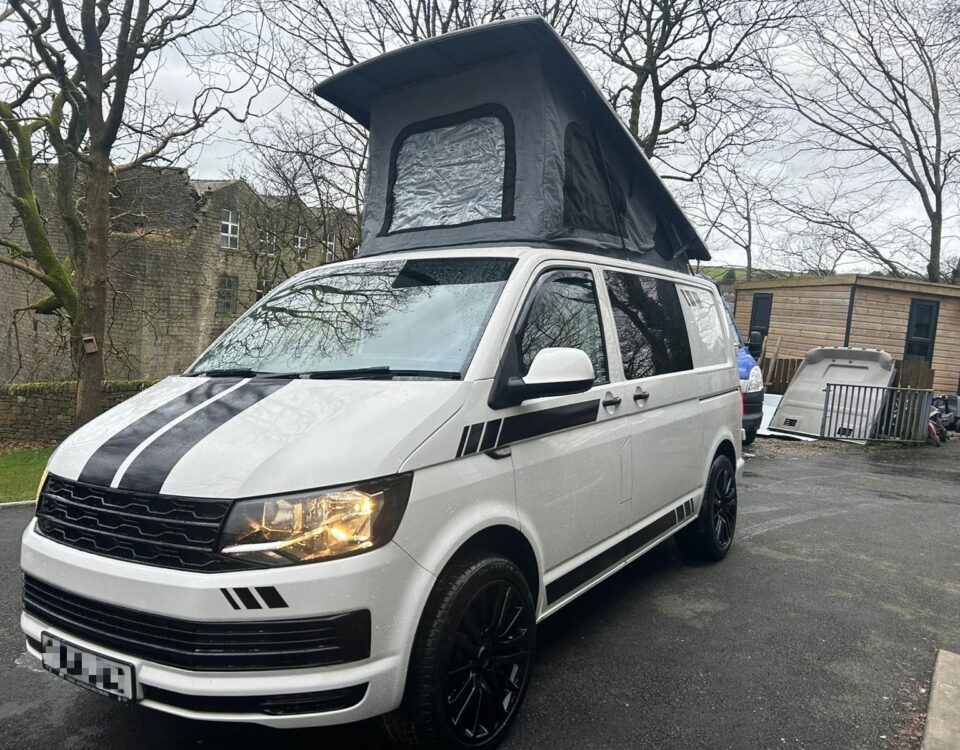 Modern 4 berth VW T6 camper van with fold-out seats and stylish interior, available to hire from NW Car Hire.