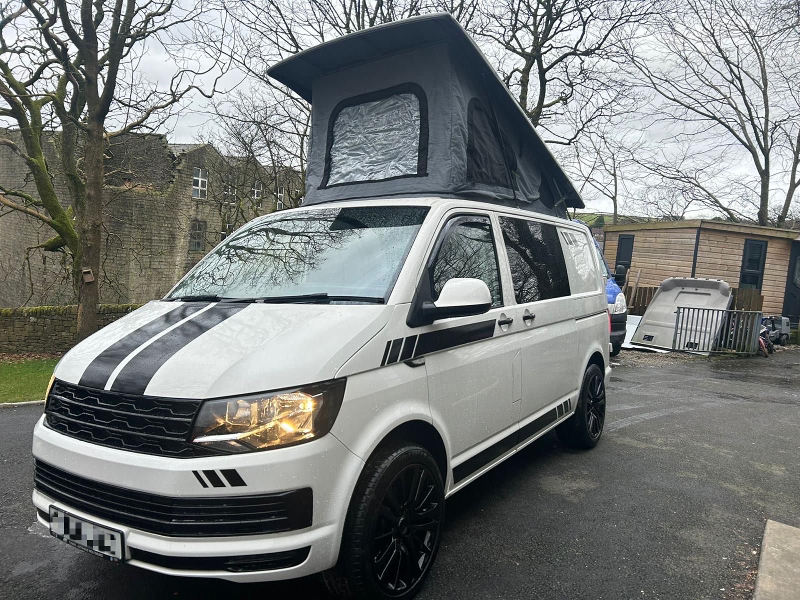Modern 4 berth VW T6 camper van with fold-out seats and stylish interior, available to hire from NW Car Hire.