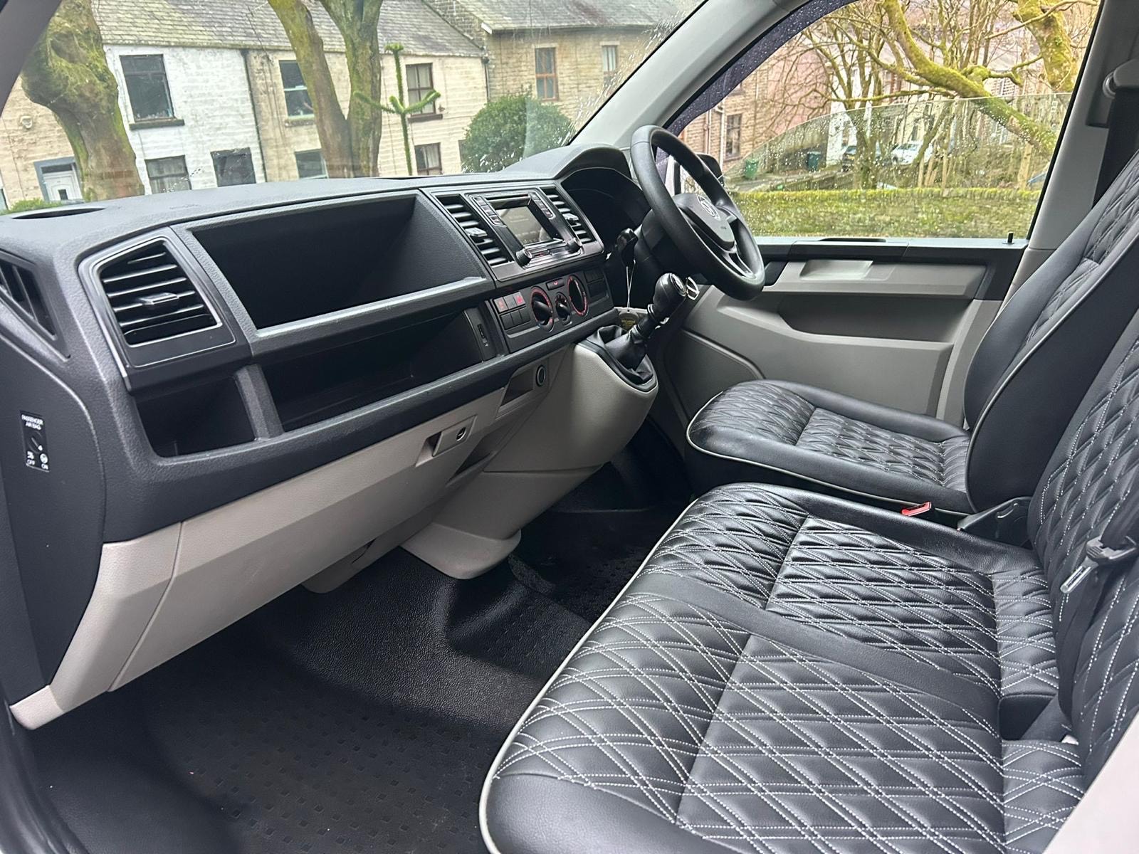 NW Car Hire Volkswagen T6 camper van interior view with premium seating and lighting for comfortable travel.