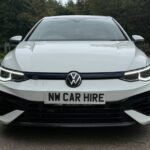 Modern white Volkswagen Golf R parked and ready for rental with NW Car Hire